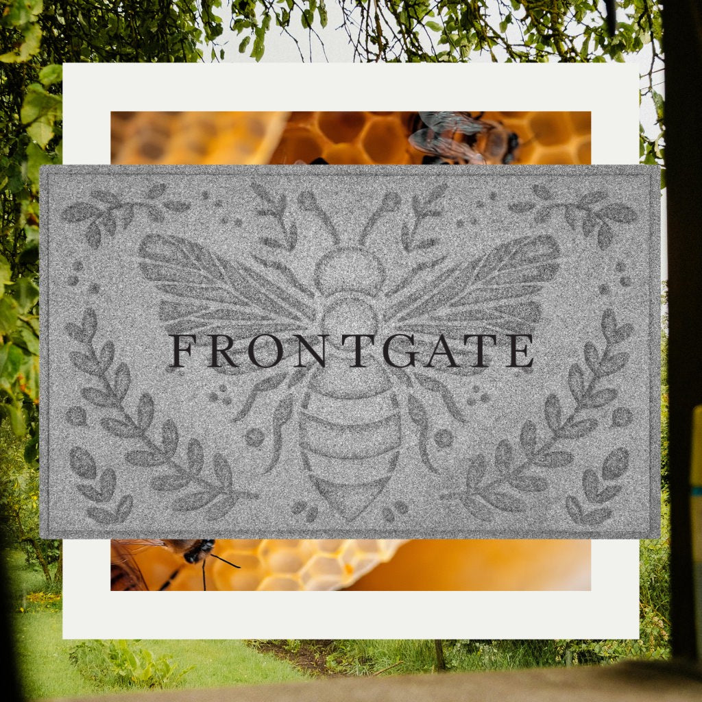 Decorative doormat with WaterHog's honey bee design and 'FRONTGATE' text, surrounded by nature-themed images.