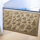 Tan/beige indoor/outdoor bi-level doormat with tree pattern on a wooden floor