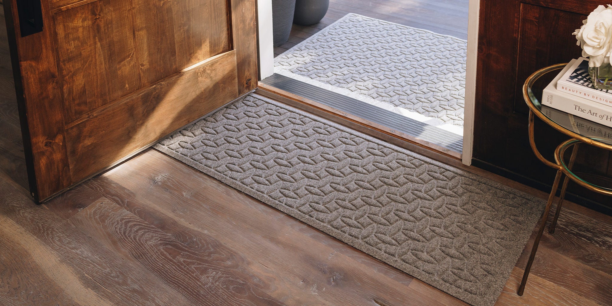 WaterHog Ellipse runner at the door protecting the wooden floors from damage and mess