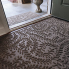 Leafy/viney textured matching doormats inside and outside a doorway