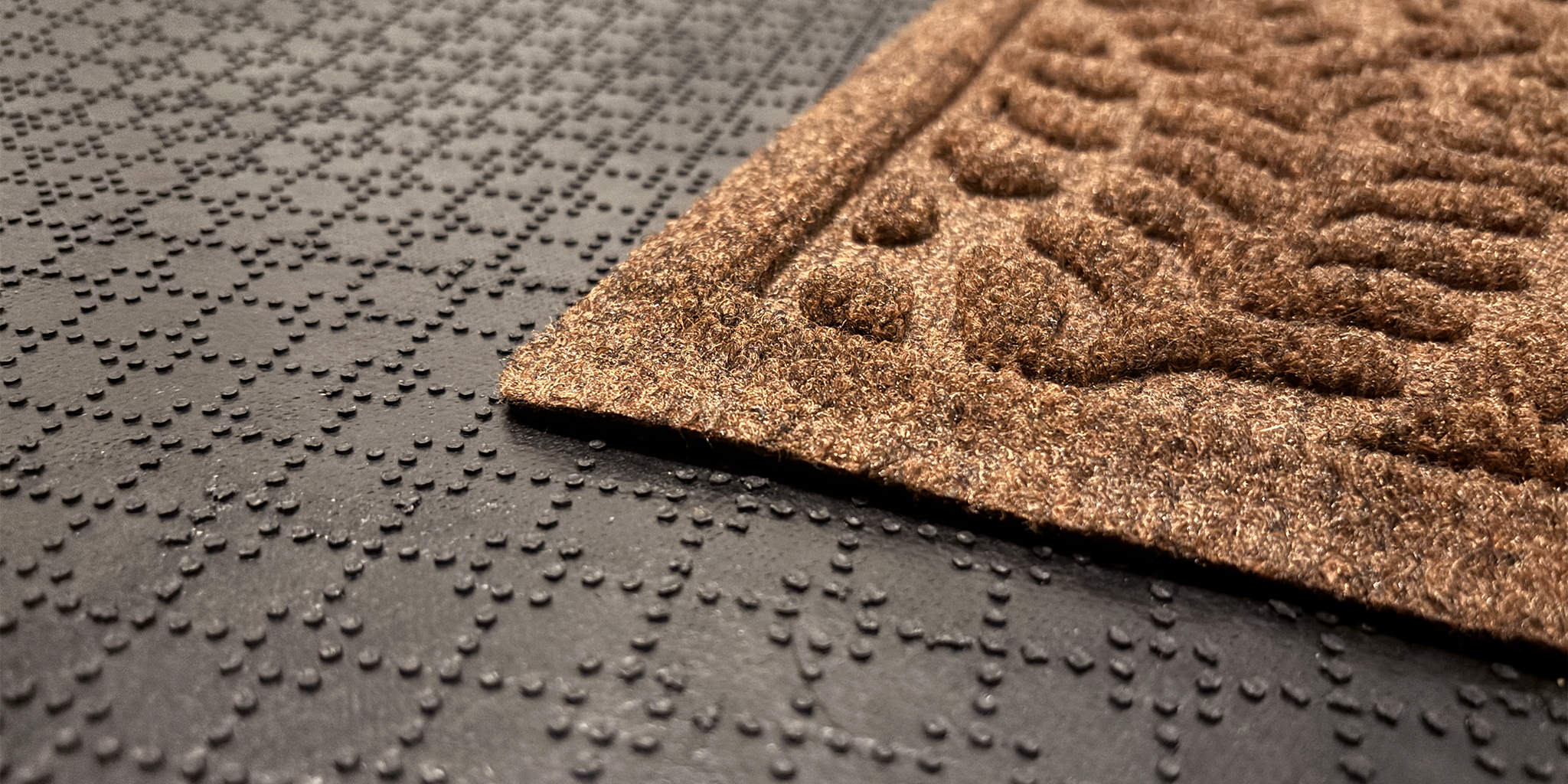 Close up of a WaterHog's bi-level design, water dam boarder, and USA-made rubber backing