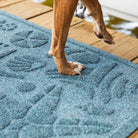 Beachcomber WaterHog mat in a sea-shell design on a deck protecting dog feet