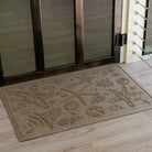 Beachcomber doormat in camel in front on wooden doors