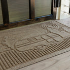 Close up of the bi-level camper design on a WaterHog doormat in front of a glass door
