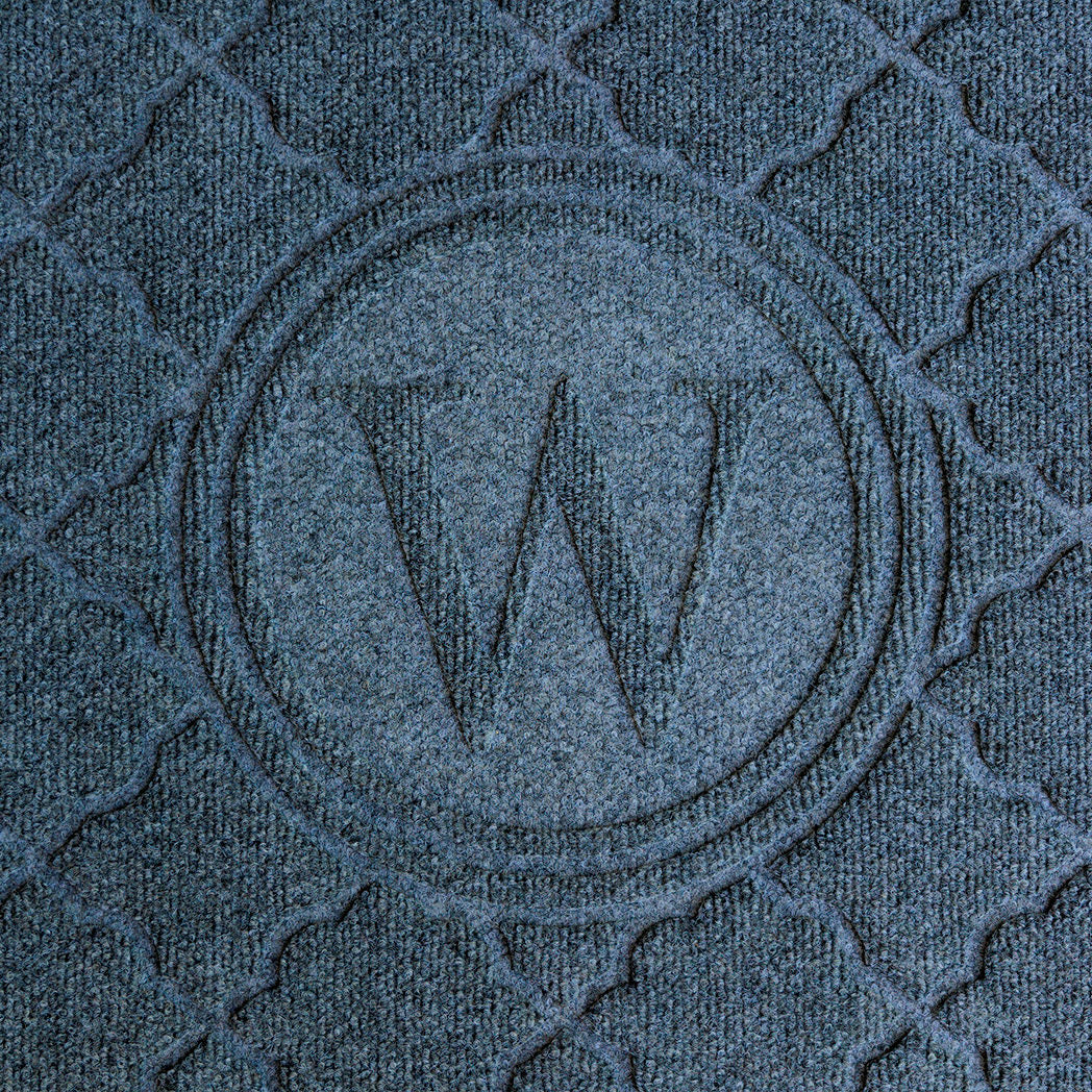 Overhead of a bi-level 'W' monogrammed mat with two circles around the 'W'