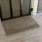 WaterHog doormat with a camper woodland design in front of glass door