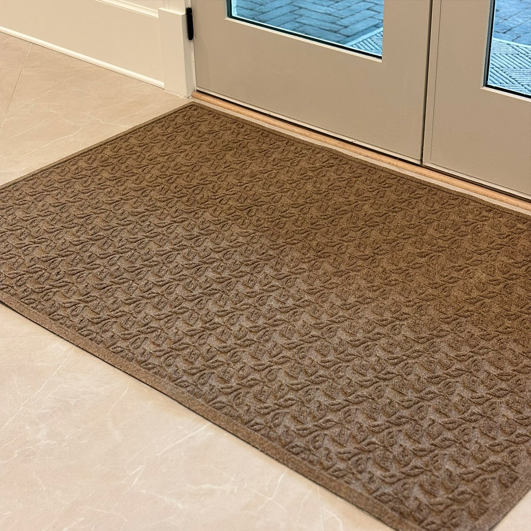 Heavy-duty indoor doormat in front of a double door