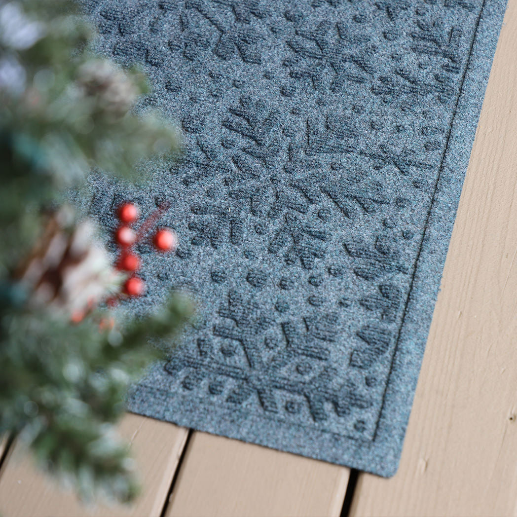 Snowflake designed doormat on an eco-friendly, fast-drying surface on a wooden deck with durable rubber backing