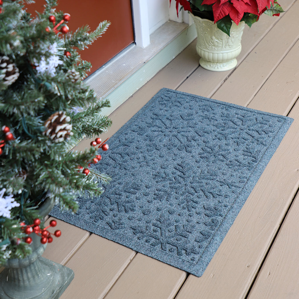 WaterHog's Snowflakes winter-ready doormat in bluestone place at a front door for dirt trapping
