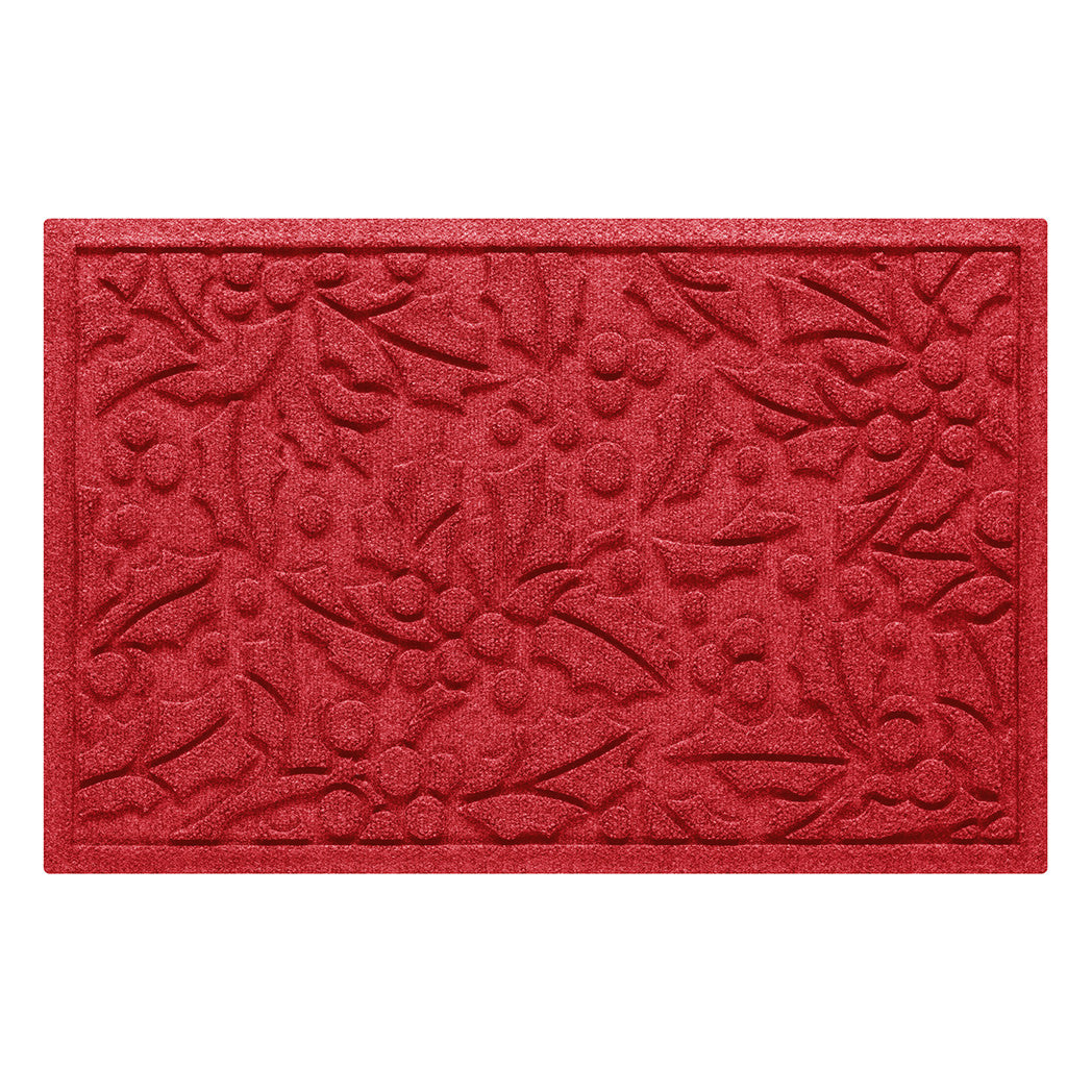 Bright red doormat with holiday holly pattern on a white background