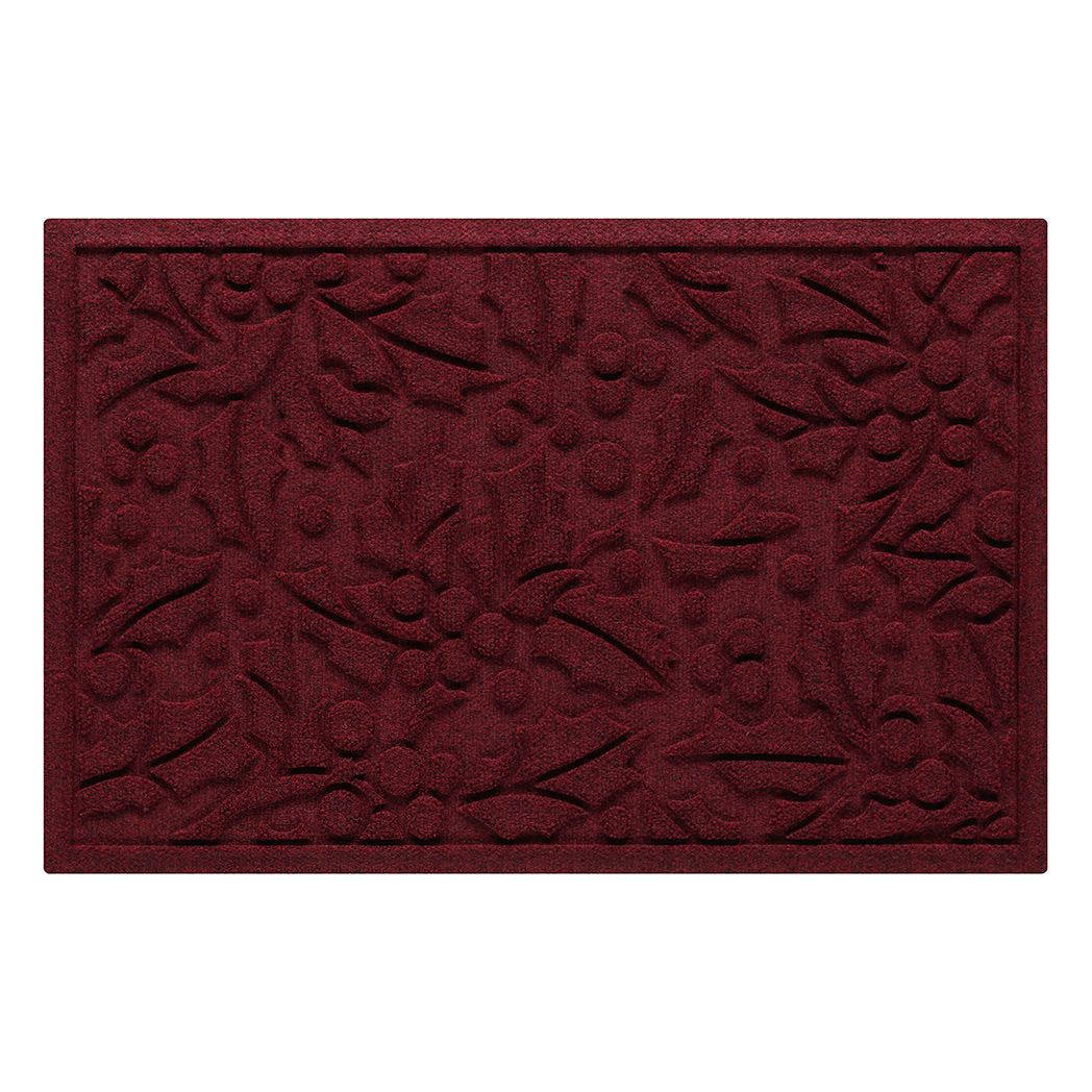 Deep red doormat with holiday holly pattern on a white background