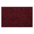 Deep red doormat with holiday holly pattern on a white background