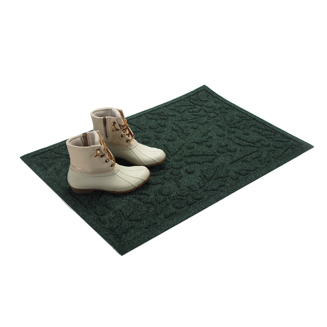 Dark green doormat with white boots on a white background