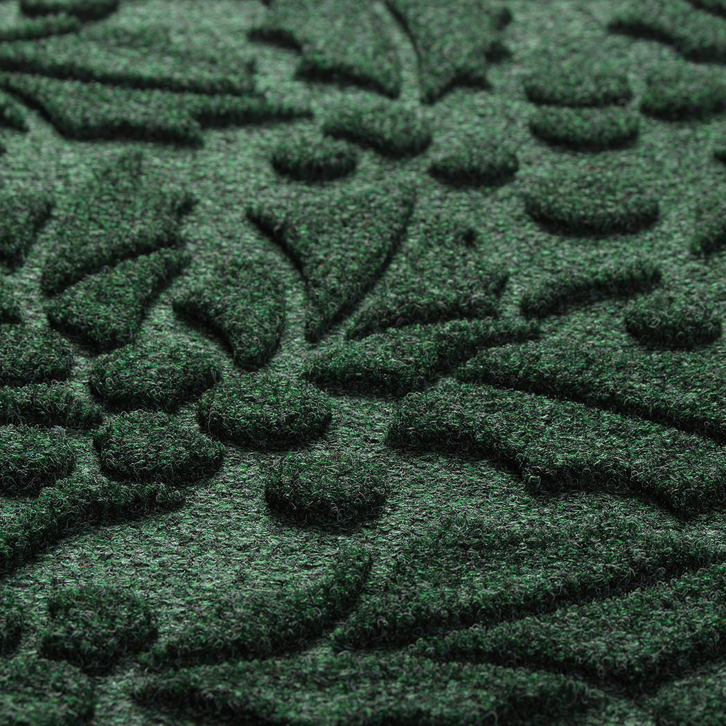 Close-up of a textured green mat with leaf patterns