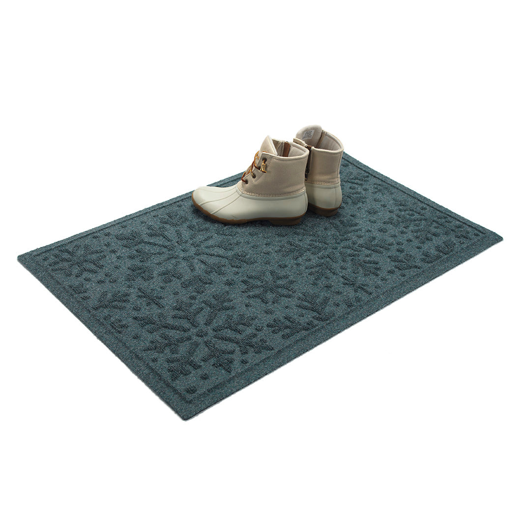 Beautiful blue doormat with patterned design on a white boots on top