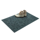 Beautiful blue doormat with patterned design on a white boots on top