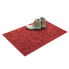 Red doormat with a bi-level snowflake pattern with white boots