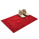 Bright red 'Merry Christmas' doormat shown at an angle with white boots on a white background