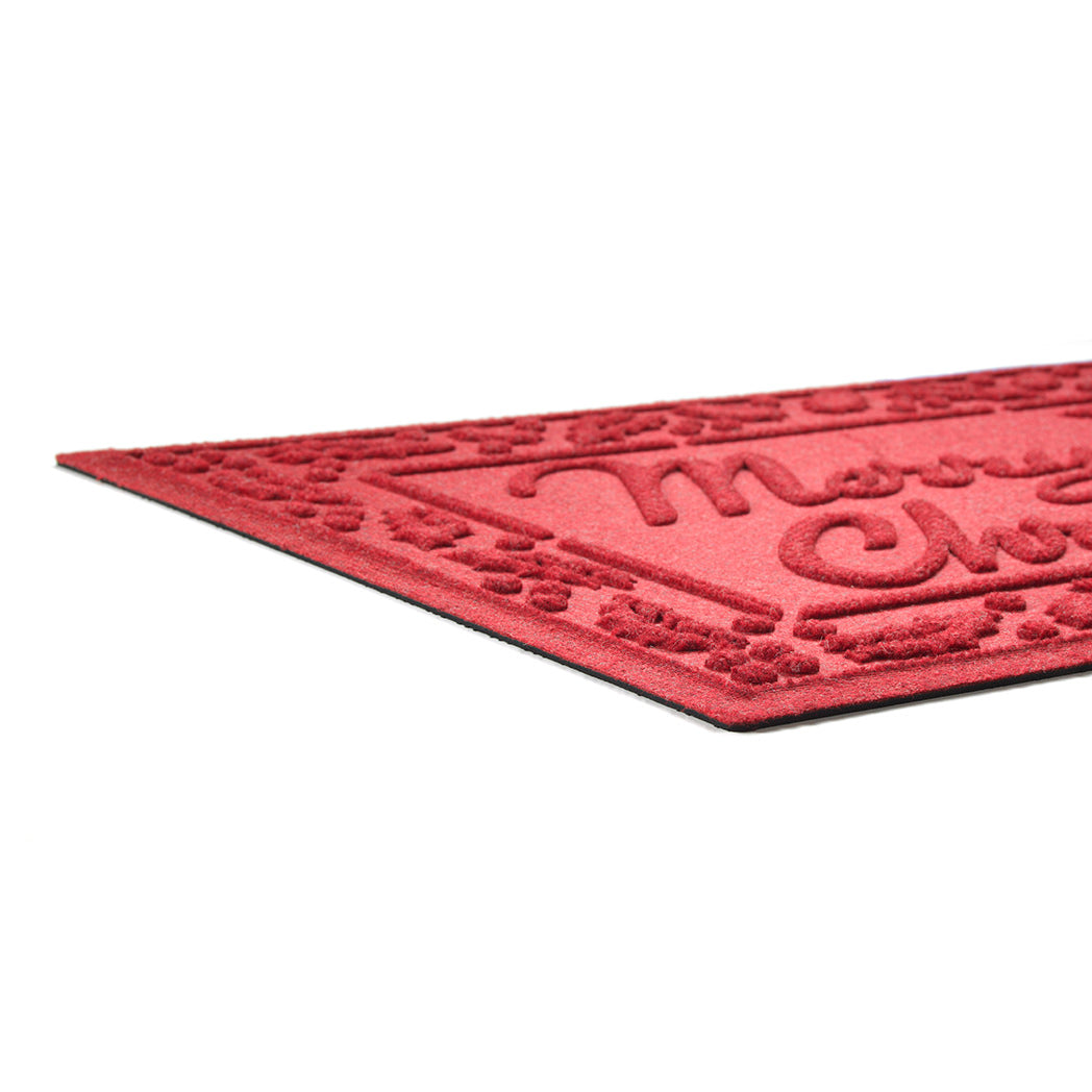 Red doormat with raised  'Merry Christmas' text and decorative border on a plain white background