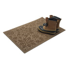 Brown doormat with a floral pattern and boots on top