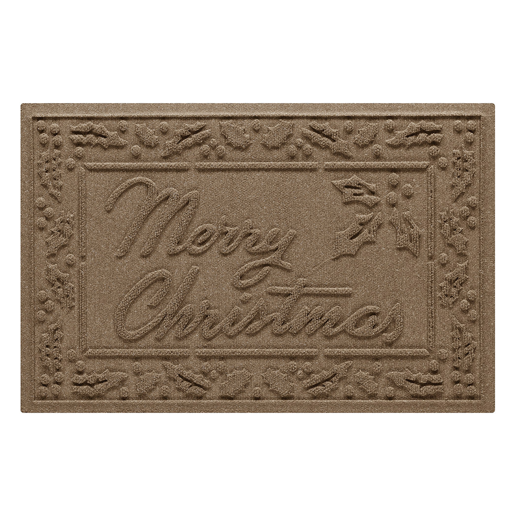 A classic camel-colored doormat with 'Merry Christmas' text and a decorative border around the edge on a white background
