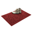 Deep red doormat with white boots on a white background