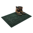Deep green single-door doormat with 'Merry Christmas' text and a pair of men's boots on a white background