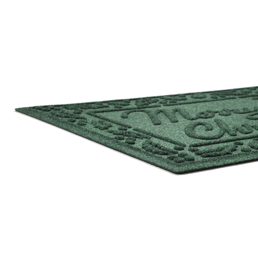Green doormat with decorative pattern on a white background