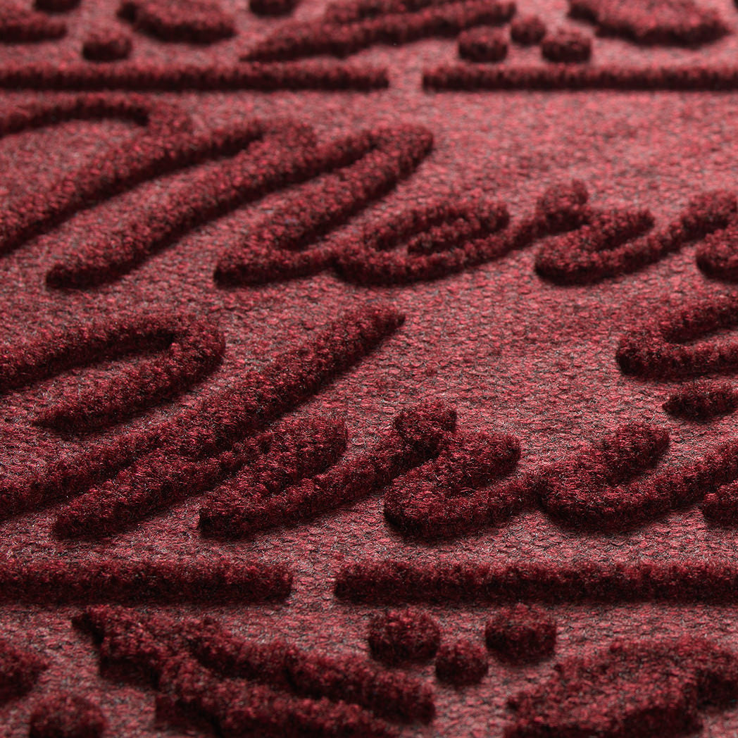 Close-up of a textured burgundy mat with raised patterns