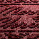Close-up of a textured burgundy mat with raised patterns