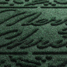 Close-up of the bi-level Merry Christmas text design in green made from eco-friendly fibers