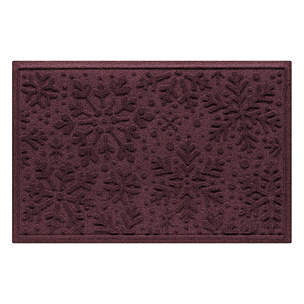 Deep red doormat with snowflake pattern on a white background