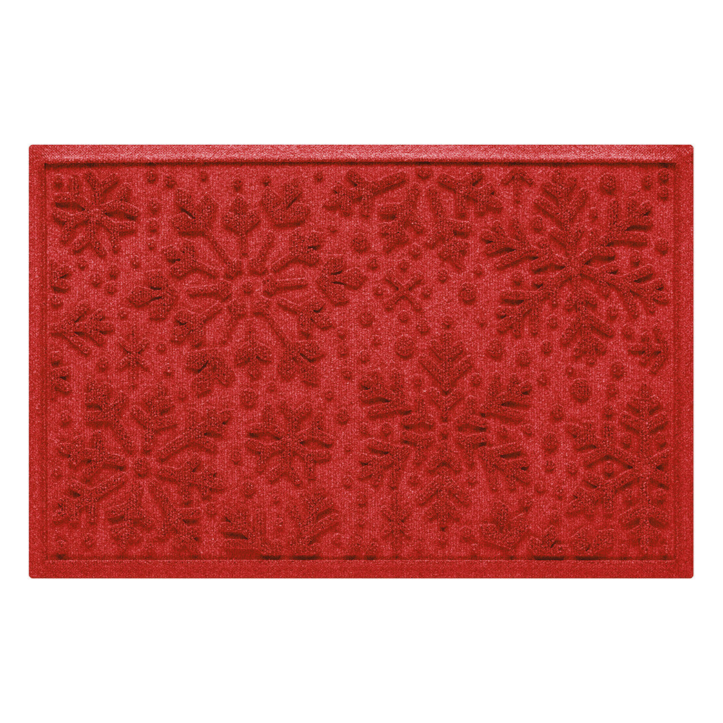 Bright red doormat with a textured snowflake pattern on a white background