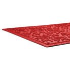 Red low-profile textured rug on a white background