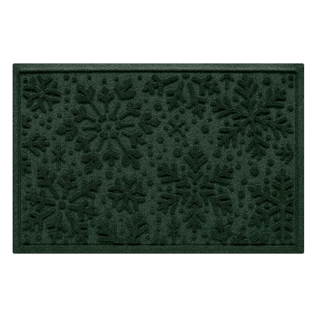 Dark green doormat with holiday snowflake pattern on a white background