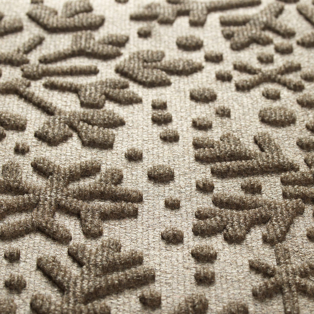 Close-up of a textured rug with a geometric pattern
