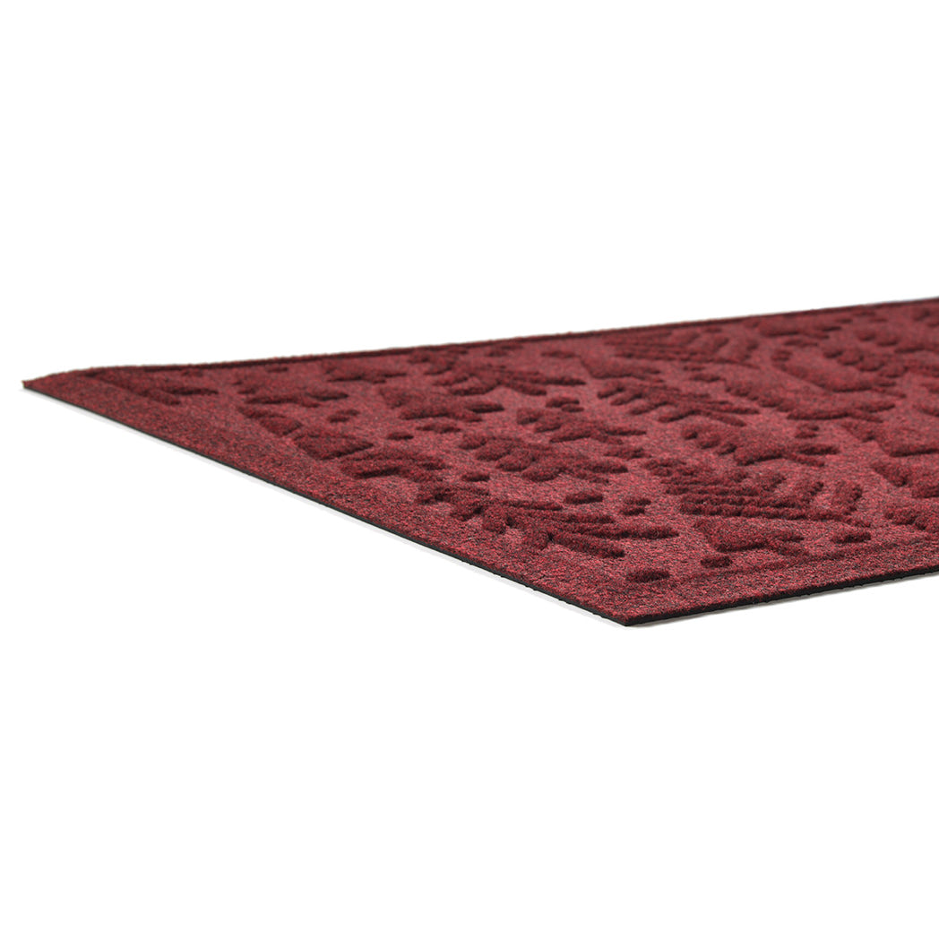 Red low-profile doormat with a textured pattern on a white background