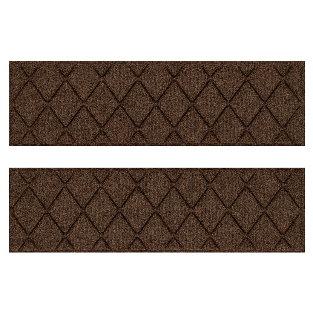 Overhead of two WaterHog indoor/outdoor stair treads in a dark earthy brown surface and interlocking diamond design for trapping dirt and moisture below shoe level.