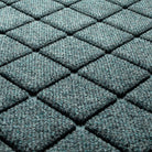 Close-up of Argyle's eco-friendly surface, made of light blue, grey, and white fibers in repeating shapes, raised diamonds for effective scraping.