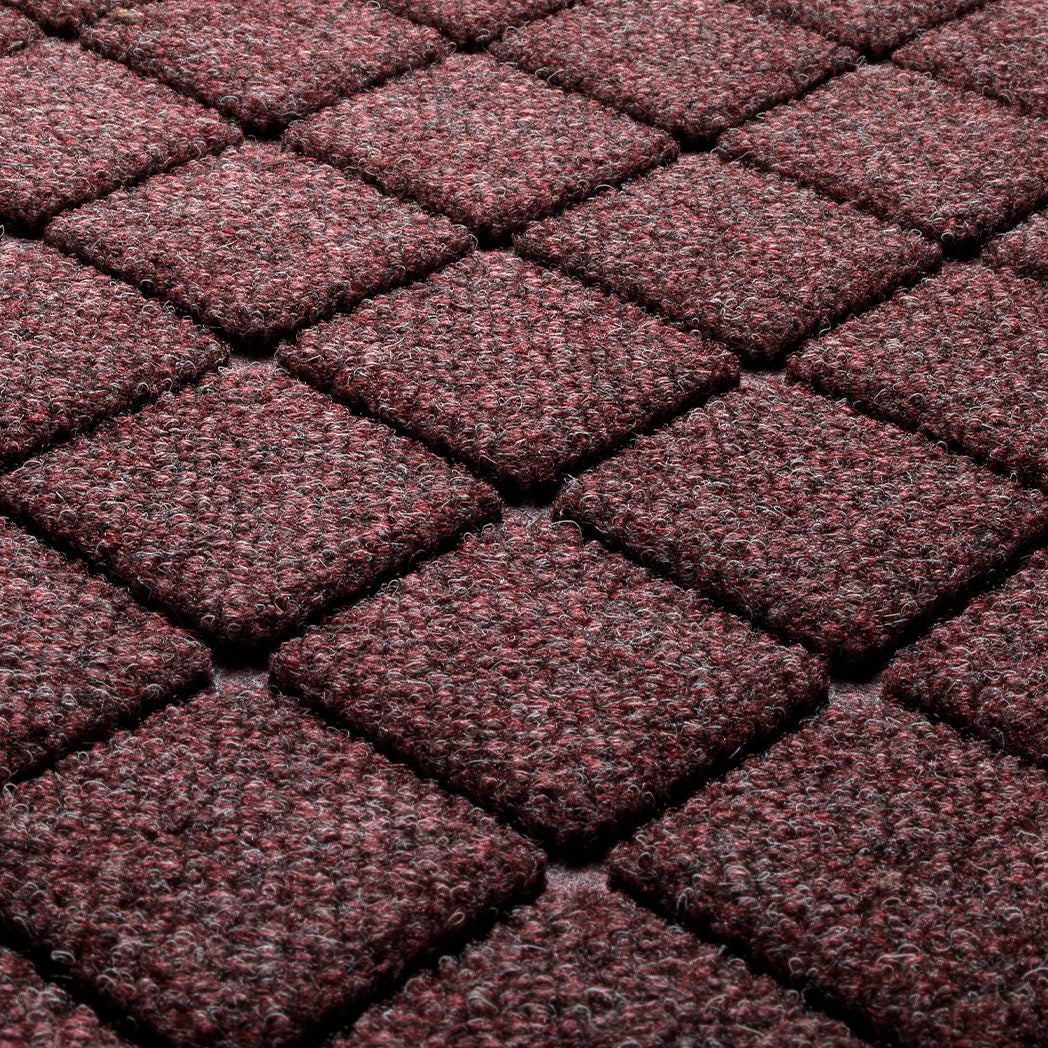 Close-up of Argyle's surface fibers made of deep wine reds, whites, and greys, pressed to make a timeless, bi-level diamond design for effective scraping.