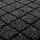 Blown-up view of WaterHog's the eco-friendly surface fibers made of various shades of grey to black, with hints of white fibers.