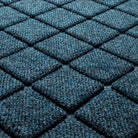 Close-up of the all-weather WaterHog durable surface made of dark and light blues, white, and grey strands, making for a fade-resistant surface.