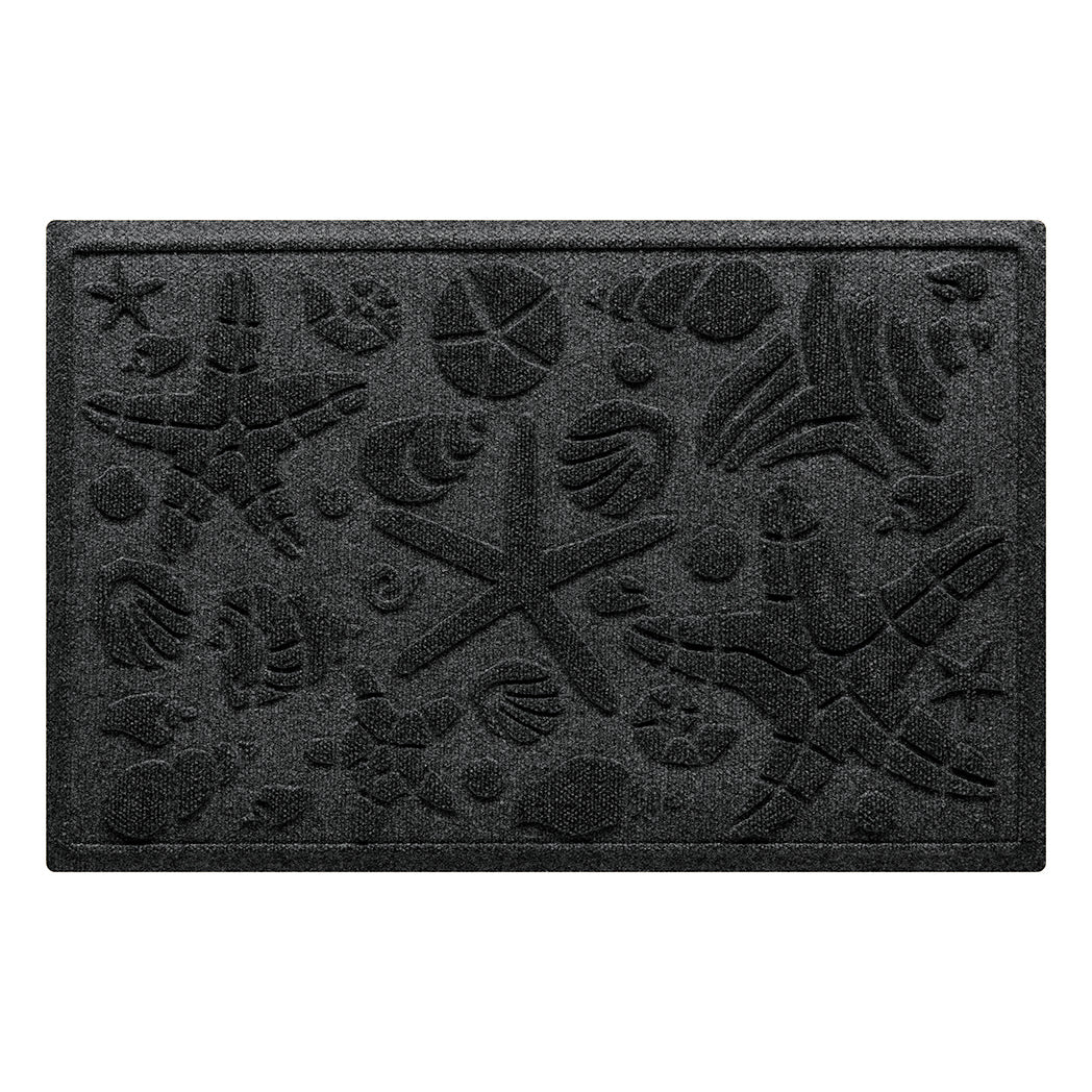 Isolated image of a nautical themed WaterHog Beachcomber medium size doormat that features a unique pattern of sea shells and starfish. Shown in dark charcoal color.