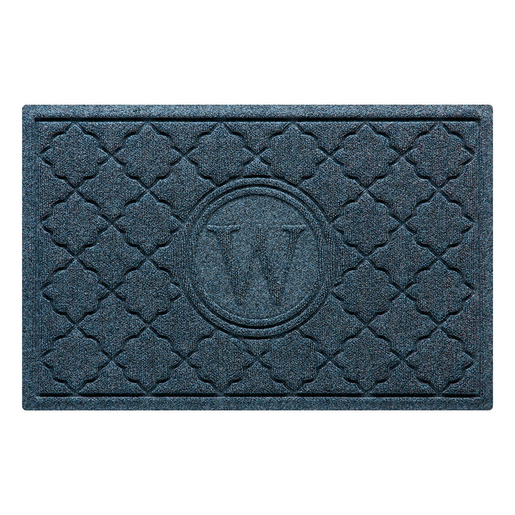 Isolated image of a WaterHog Bombay Monogrammed Outdoor Doormat that features a classic repeating geometric pattern with an encircled letter placed in the center; shown in a navy color.