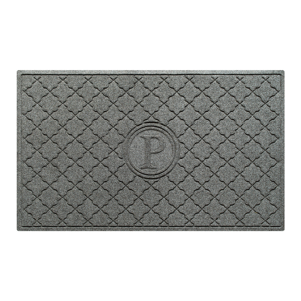 Isolated image of a large WaterHog Bombay Monogrammed Outdoor Doormat that features a classic repeating geometric pattern with an encircled letter placed in the center; shown in a medium grey color.