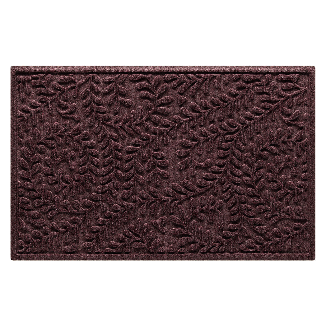 Overhead of a WaterHog Boxwood outdoor medium door mat with a deep wine red curling botanical design, backed by durable rubber for maximum traction.