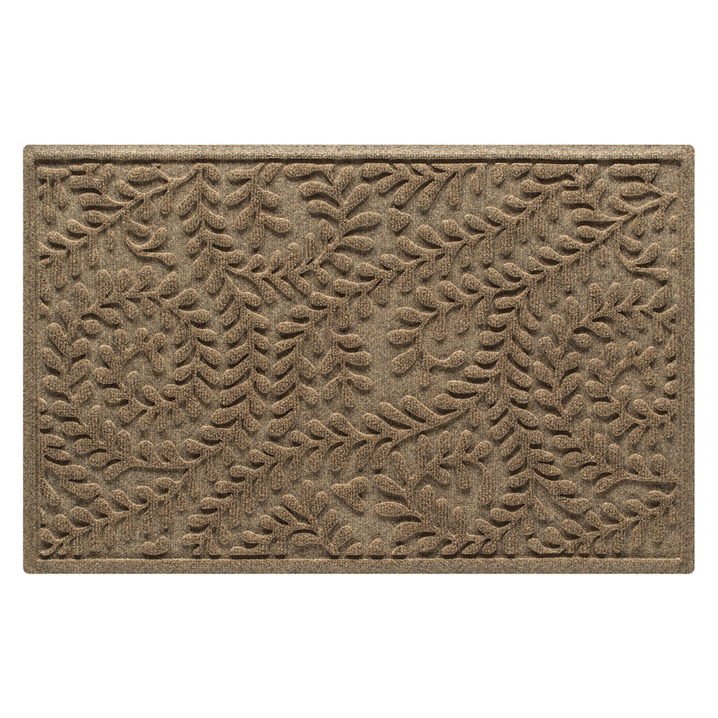 WaterHog Boxwood indoor/outdoor doormat is in a light tan color and has a curling botanical, bi-level design for an outdoorsy or floral appeal.