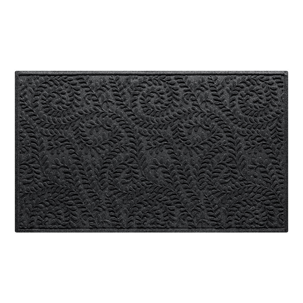 Overhead of a WaterHog 3x5 indoor/outdoor modern door mat with a deep grey color and curling botanical design to match virtually any home style.