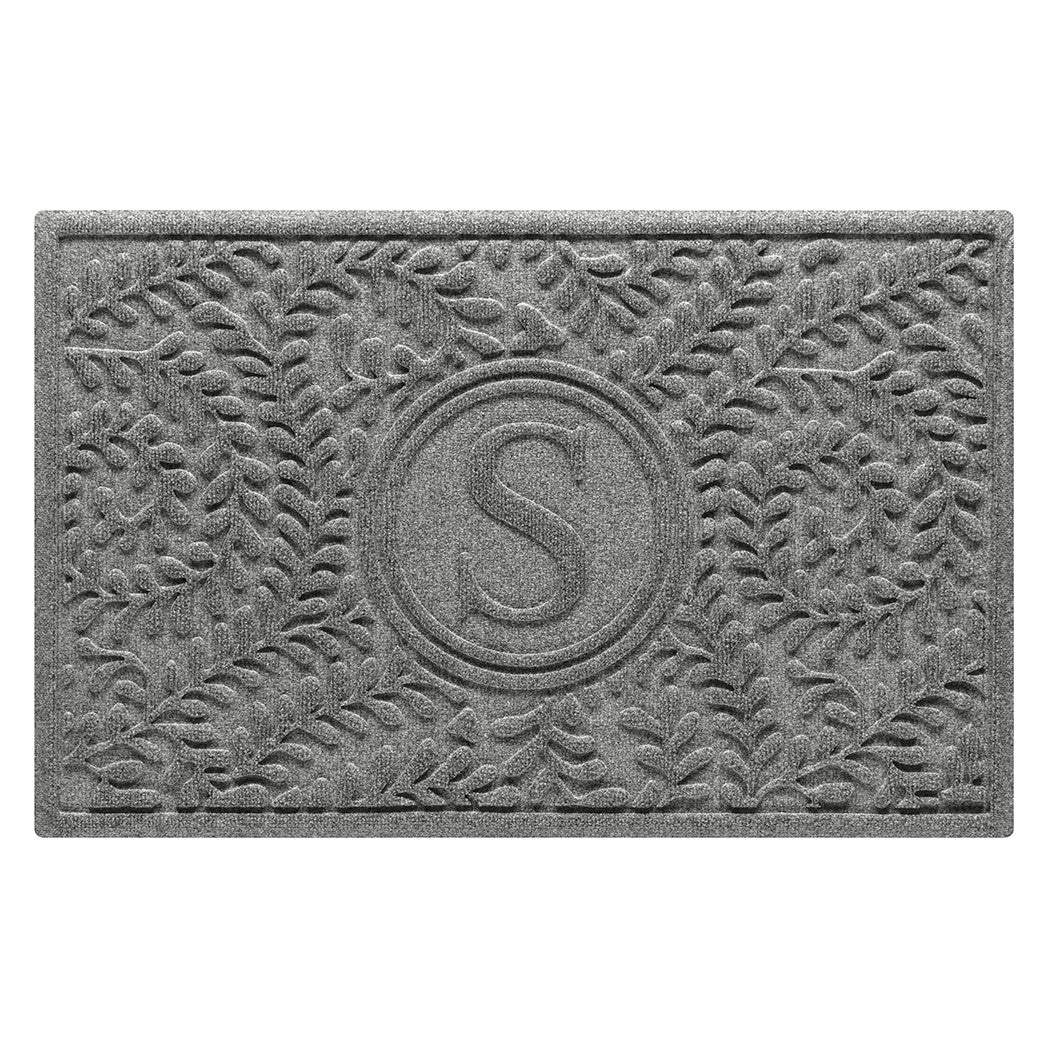 Personalized WaterHog medium Boxwood doormat in a light grey surface and curling botanical pattern.
