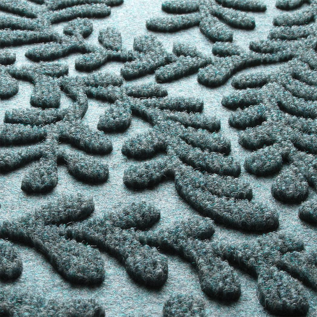 Detail shot of the all-weather WaterHog's durable, eco-friendly surface made of light blue, grey, and white fibers.